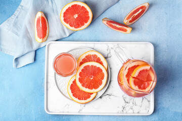 Composition with fresh grapefruit juice on table