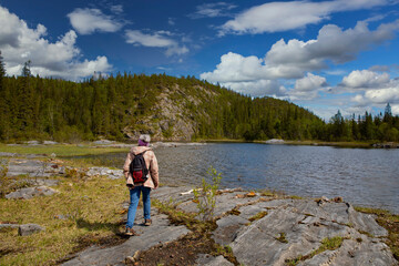 Woman On river banks  in Velfjord wild nature, Northern Norway