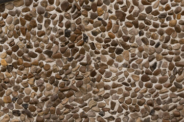 The pattern on the floor of light and dark pebbles. Modern mosaic of natural material.