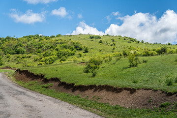 Tranquil Hilltop Landscape with Blue Sky and Clouds
