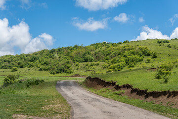 Tranquil Hilltop Landscape with Blue Sky and Clouds
