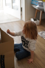 Fototapeta na wymiar girl painting on a box in self-isolation