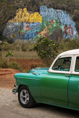 Old american car with colourful mural wall from Vinales, Cuba