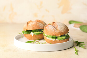 Plate with tasty cucumber sandwiches on table