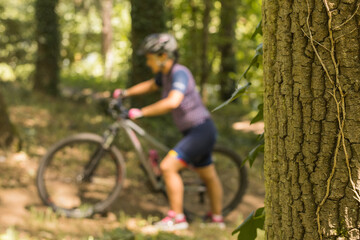 Fototapeta na wymiar woman doing mountain biking among nature