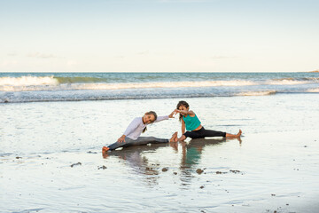 Children playing and exercising on the beach