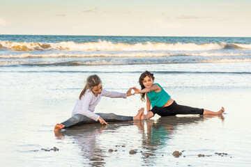 Children playing and exercising on the beach