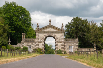 Fototapeta na wymiar Impressive arch gate at the entrance to the Fonthill Lake, Abbey and Estate set in the countryside in Wiltshire