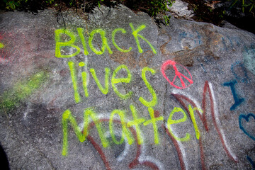 Black Lives Matter spray painted on a rock.