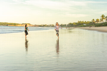 Children exercise running on the beach with drop shadow