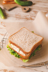 Tasty cucumber sandwich on table
