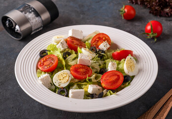 Vegetables, quail eggs and cheese on a plate. Tasty diet salad.