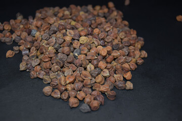 Fresh Dried black chickpeas as an abstract background texture, Black dried black chickpeas on black background.