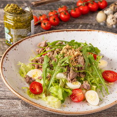 Turkey salad with quail eggs, tomatoes, and walnuts
