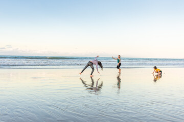 Children exercising on the beach juggling joy