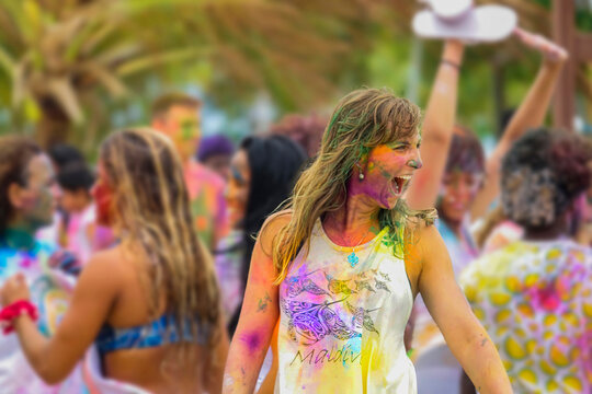 CLOSE UP: Young Caucasian woman wears face paint and parties in the rain.