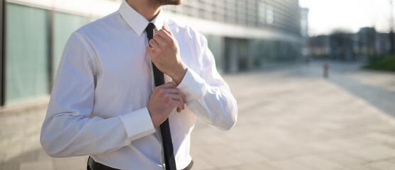 Businessman adjusting his shirt's cuff