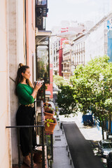 Woman enjoying her coffee on the balcony.