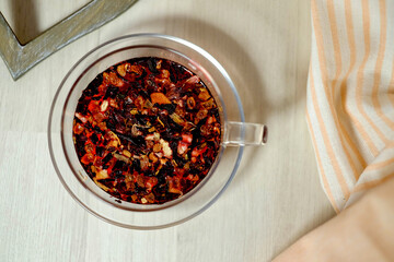 cup of herbal tea on table and pink tea towel