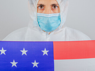 Portrait of a caucasian female doctor wearing ppe suit and mask in hospital.