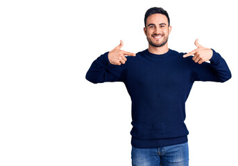 Young handsome man wearing casual clothes looking confident with smile on face, pointing oneself...