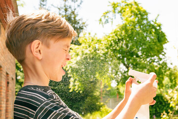 A small boy is doused with water