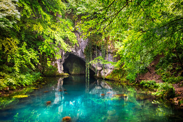Pond on wellhead of river surrounded with forest and cave on Krupajsko vrelo in Serbia. Beautiful...