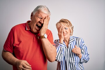 Senior beautiful couple standing together over isolated white background Yawning tired covering half face, eye and mouth with hand. Face hurts in pain.