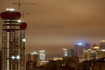 The construction of a high-rise building in the city. Moscow apartments at night. Moscow City. Moscow, Russia.
