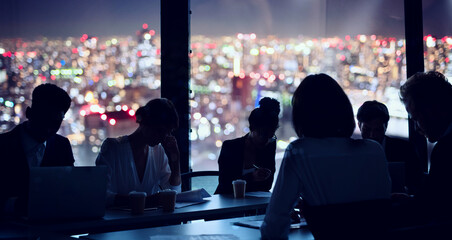Businessmen that work together in office at night. concept of teamwork and partnership.