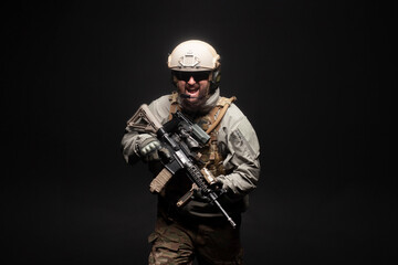 Fototapeta premium American commando in military equipment and arms running at night, ranger screaming in the dark, elite troops, war concept