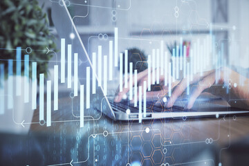 Double exposure of woman hands typing on computer and forex chart hologram drawing. Stock market...