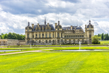 Fototapeta na wymiar Famous Chateau de Chantilly (Chantilly Castle, 1560), is a historic chateau located in town of Chantilly, Oise, Picardie, France. 