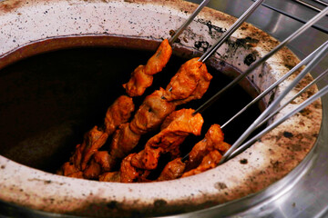spice marinated chicken cubes ( chicken tikka )skewers cooking in a clay oven known as tandoor - obrazy, fototapety, plakaty