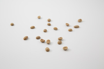 Close up shot of raw coffee beans isolated on white background with copy space