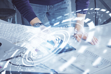 Double exposure of man's hand holding and using a digital device and data theme drawing. Technology concept.