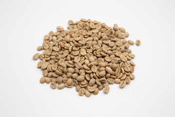 Close up shot of raw coffee beans isolated on white background with copy space