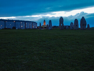 standing stone at sunset with clouds