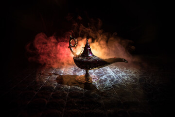 Lamp of wishes concept. Antique Aladdin arabian nights genie style oil lamp with soft light white...