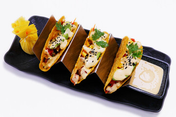 traditional Mexican dish taco,consisting of a small hand-sized corn or wheat tortilla topped with a filling