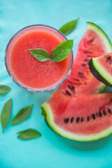 Fresh Watermelon Juice, Smoothie on Blue Background with Watermelon Slice and Mint Leaves, Top View