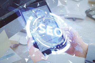 Multi exposure of man's hands holding and using a digital device and seo drawing. search optimization concept.