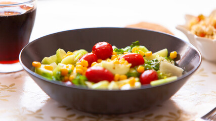 Healthy green salad. bowl of salad with vegetables and greens on table