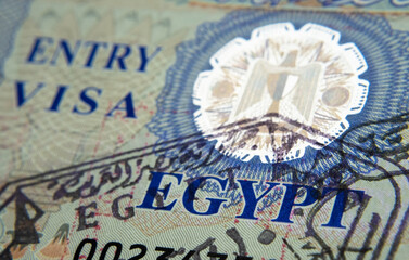 Egyp entry visa sticker with a stamp in passport made by immigration officer at border and visa control. Selective focus. Macro photo.
