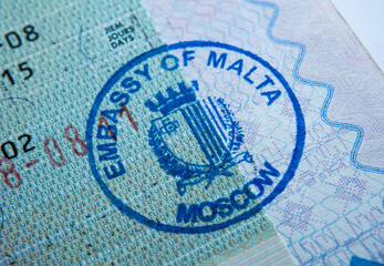 Stamp of the embassy of Malta in passport. Made by immigration officer at Maltese embassy in Moscow. Selective focus. Macro photo.