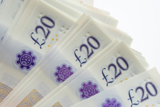 Corner of the stack of 20 pound banknotes isolated on white. Photo of new polymer 20 pound note released in februrary 2020 in the United Kingdom.