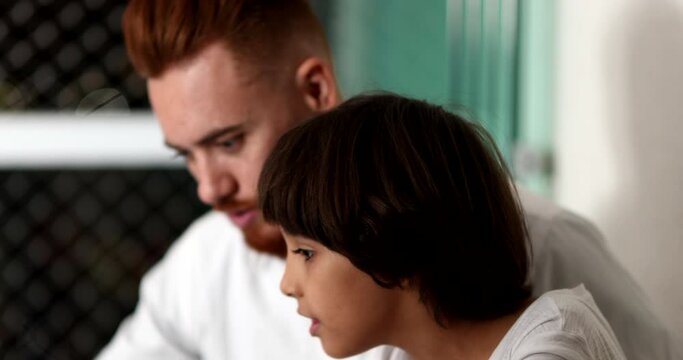 Parent And Child Bonding Together In Front Of Laptop Computer. Ethnic Diverse Family