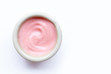 Sour cream or yogurt  on white bowl on white