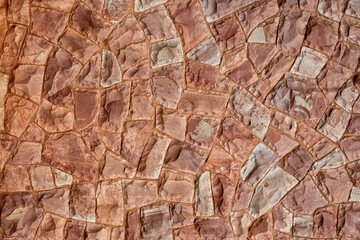 Decorative stone wall in pink tones, for use in background