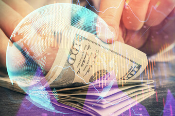 Multi exposure of forex graph drawing hologram and USA dollars bills and man hands. Technical...